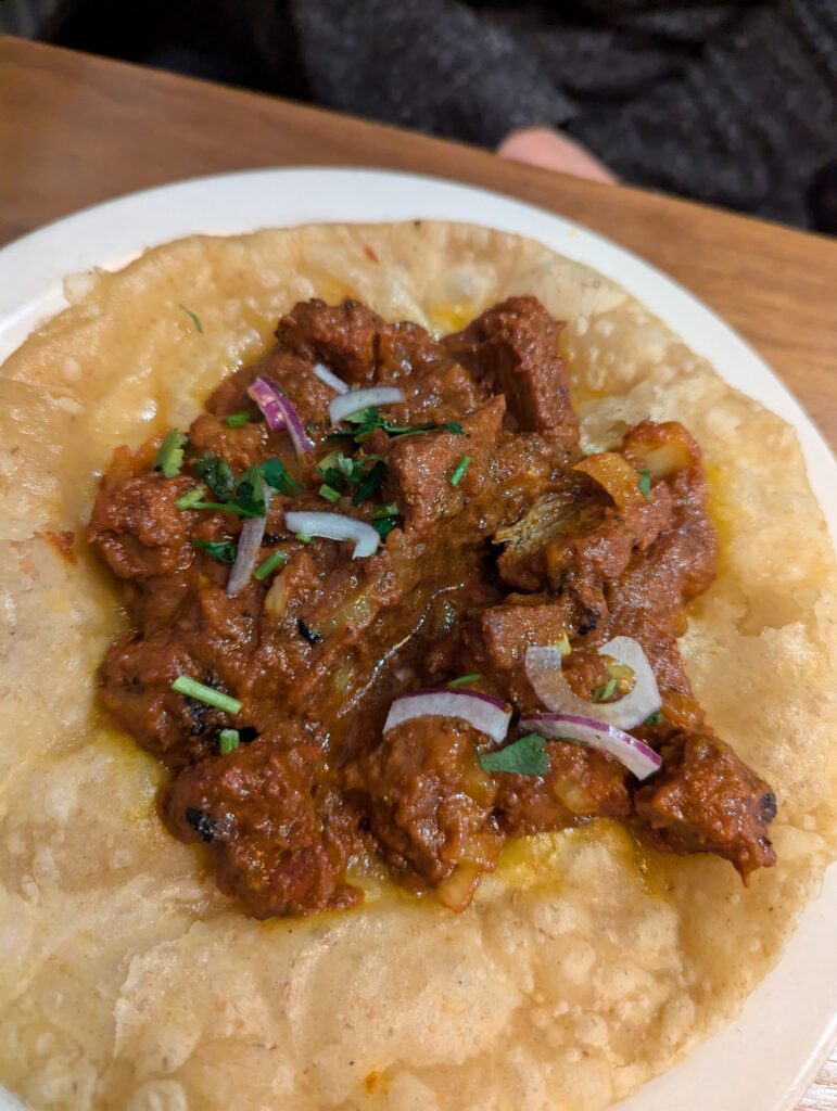 A Lamb Puri - a style of medium curry on a small flatbread